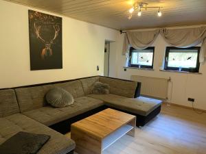 a living room with a couch and a coffee table at Zum Goldenen Tal in Gräfendhron