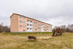 a building with a playground in front of a building at Pärnu Spa Duplex for 8 in Pärnu