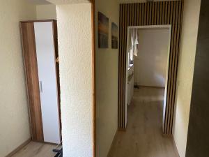 a hallway with two mirrors and a hallway with a kitchen at Zum Goldenen Tal in Gräfendhron