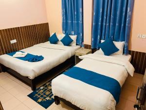 Łóżko lub łóżka w pokoju w obiekcie Hotel White Yak