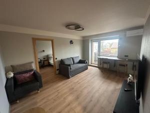 a living room with a couch a chair and a desk at Mare et Ventus in Ventspils +19 photos