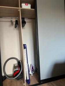 a closet with a fire hose and baseball bats at Mare et Ventus in Ventspils