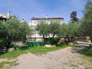 a park with trees and a building in the background at Bernarda in Sveti Vid-Miholjice