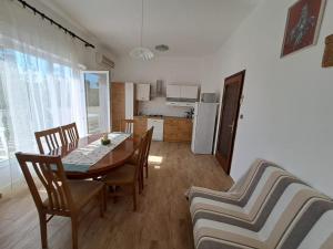 a kitchen and dining room with a table and chairs at Bernarda in Sveti Vid-Miholjice