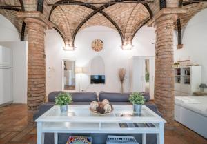 a living room with a couch and a table at Loft of Love in Reggio Emilia