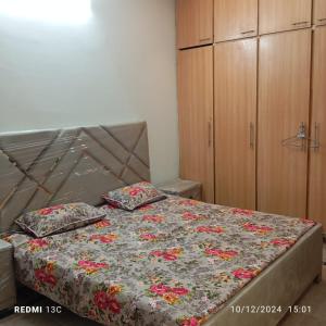a bed with two pillows on it in a bedroom at 5 Marla safari valley bahria Phase 8 in Rawalpindi