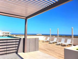 a patio with a view of the ocean at Amaterra 304D Seaside Luxe Condo in Cabo San Lucas