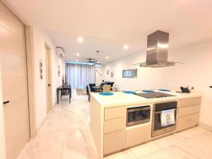 a kitchen with a stove and a counter top at Amaterra 304D Seaside Luxe Condo in Cabo San Lucas