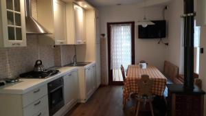 a kitchen with a table and a dining room at Casa Vacanze Tel 121 in Pieve Tesino