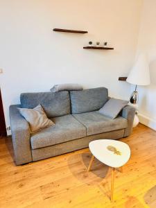 una sala de estar con un sofá y una mesa en Appart T2 Quartier Beaujardin, en Tours