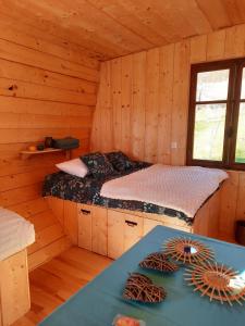 a bedroom with a bed in a wooden cabin at La cabane d'Elisa in Oëy