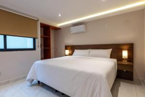 Postel nebo postele na pokoji v ubytování Hotel 28 Cancun