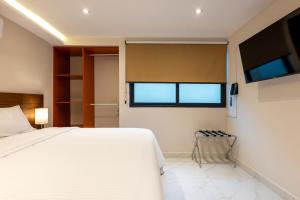 TV a/nebo společenská místnost v ubytování Hotel 28 Cancun