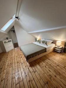 a bedroom with a bed and a wooden floor at Villa de charme La Belle Havraise 6 pers 3 chambres terrasse avec garage in Le Havre