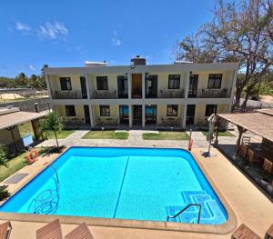 an empty swimming pool in front of a building at Cotton Beach Holidays in Saint Francois