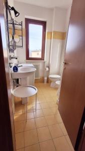 a bathroom with a sink and a toilet at The Little House in Rieti