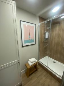 a bathroom with a shower and a glass shower stall at Beautiful Historic Cottage in Callander