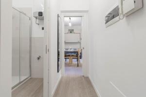 a hallway leading to a dining room with a table at Volta Apartment - Sanremo in Sanremo