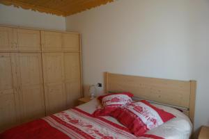 a bedroom with a bed with two pillows on it at Dolomites with Love in Mazzin +11 photos