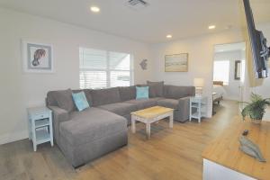 a living room with a couch and a table at Jensen Surf Shack in Jensen Beach +32 photos