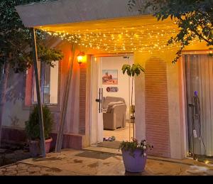 a house with a porch with lights on it at Koonjak in Bukhara