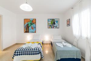 Ένα ή περισσότερα κρεβάτια σε δωμάτιο στο Villa Galene Del Mar +11 φωτογραφίες