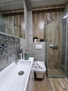 a bathroom with a sink and a toilet and a shower at Lemon Bliss Studio in Skopje +16 photos