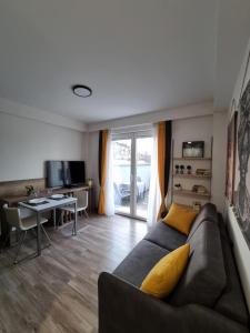 a living room with a couch and a table and a desk at Lemon Bliss Studio in Skopje