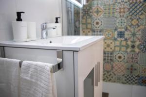 a bathroom with a white sink and a shower at Apartamento las setas in Seville