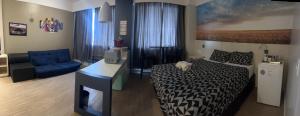 a hotel room with a bed and a blue chair at FLAT NO CORAÇÃO De ALPHAVILLE in Barueri