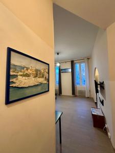 a living room with a painting on the wall at Joli Appartement aux Chartreux - Calme & lumineux in Marseille +13 photos