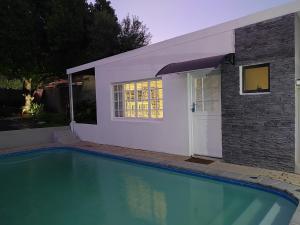 a swimming pool in front of a house at La Damon 1 in Paarl