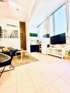 a living room with a couch and a tv at צימר פרטי בבוגרשוב VIp אופציה לחניה in Tel Aviv