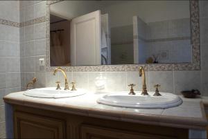 a bathroom with two sinks and a large mirror at Le Balcon De Roxane in Malaucène +26 photos