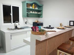 a kitchen with a counter with a sink and a counter top at Heaven apart cerca del aeropuerto las Américas in Monte Adentro