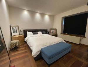 a bedroom with a large bed and a large window at Le Clos du Châtelain, in Profondeville +40 photos