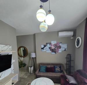 a living room with a couch and two lights at Blue View Apartment in Himare +12 photos