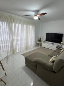 a living room with a couch and a flat screen tv at Casa con terraza en La Plazuela in Arrecife