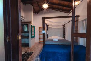 a bedroom with a bunk bed with a blue comforter at House da Lui in Ubatuba