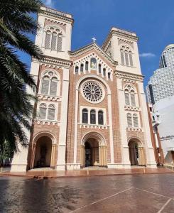 a large church with a clock on the front of it at 3BR 5BedVilla Silom China town BTS Surasak Special offer in Chinatown