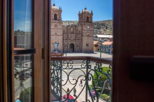 a view of a church from a window at Hotel Hacienda Plaza de Armas in Puno