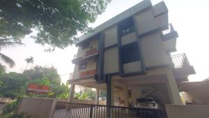 a large building with a sign in front of it at Orange valley Residency Thodupuzha in Thodupuzha