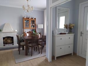 a dining room with a table and a fireplace at Casa do Olmo in Porto de Espasante