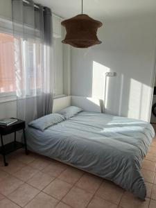 a bed sitting in a room with a window at Central Menton Beach Retreat in Menton