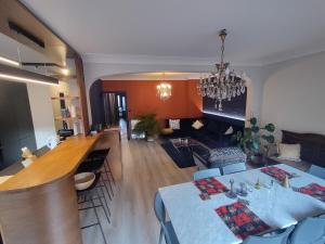 a living room with a table and a dining room at LifeinLiege in Liège