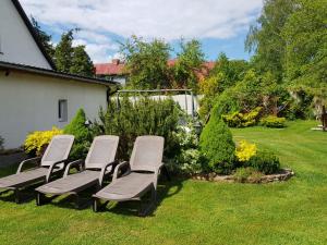 a group of chairs sitting in a yard at Noclegi u Agnieszki in Jarnołtówek