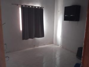 a room with a black curtain and a window at Solar dos Rabelo in Belém