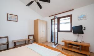 a bedroom with a bed and a tv on the wall at apartmani Nik in Bibinje