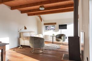 a bedroom with a bed and a chair and a table at Typisch in Halle