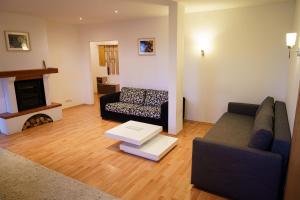 a living room with a couch and a fireplace at Spacious apartment with a fireplace in the city in Bratislava